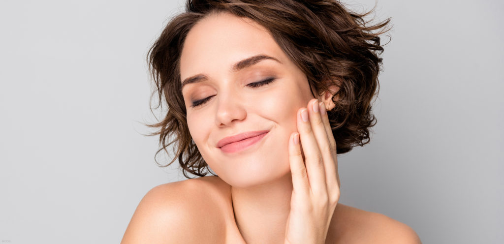 Brunette woman with great skin after HydraFacial® treatments