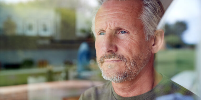 Man staring out a window